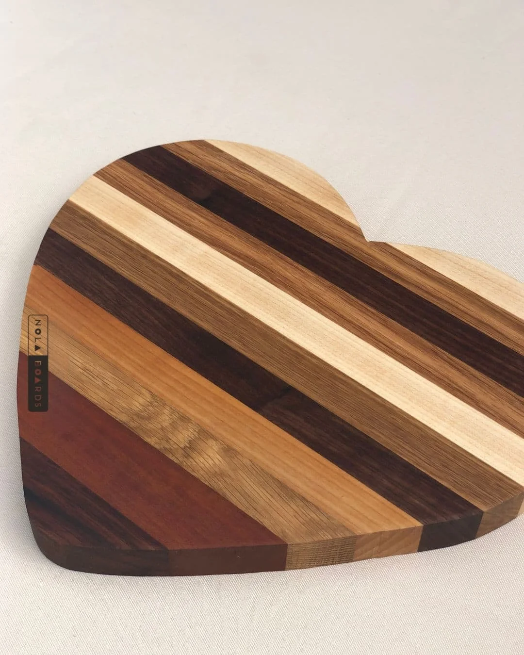 HEART SHAPED WOODEN CUTTING BOARD – MIXED WOODS 10”